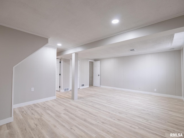 basement with a textured ceiling and light wood-type flooring