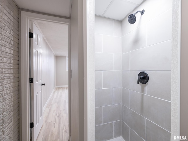 bathroom featuring a shower and hardwood / wood-style floors