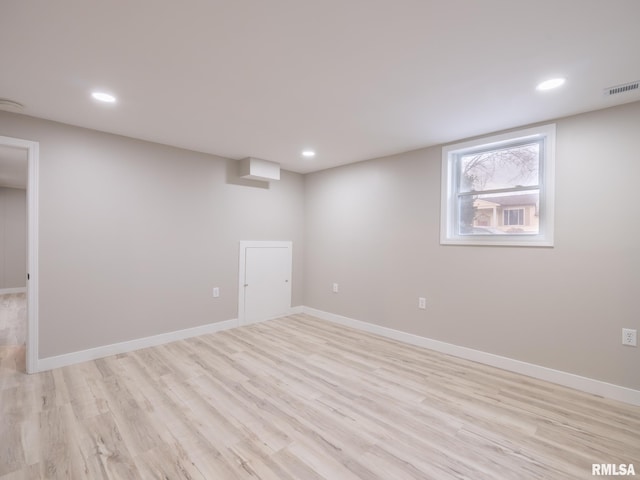 basement with light hardwood / wood-style flooring