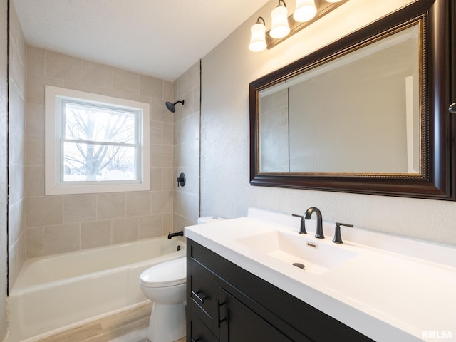 full bathroom featuring vanity, toilet, tiled shower / bath combo, and wood-type flooring