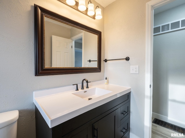 bathroom with toilet and vanity