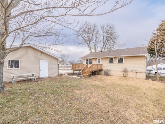 rear view of property with a wooden deck, a lawn, and central air condition unit