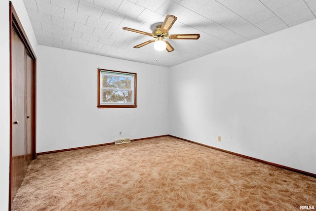 interior space with carpet and ceiling fan