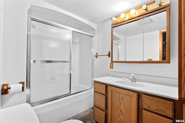 full bathroom with vanity, toilet, and combined bath / shower with glass door