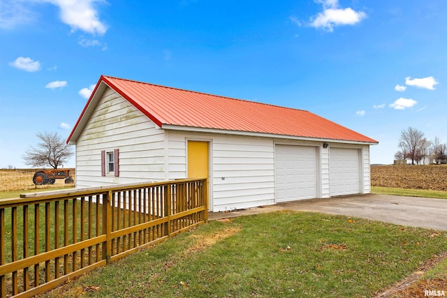 garage featuring a lawn