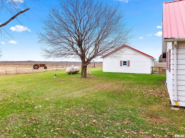 view of yard with an outbuilding and a rural view