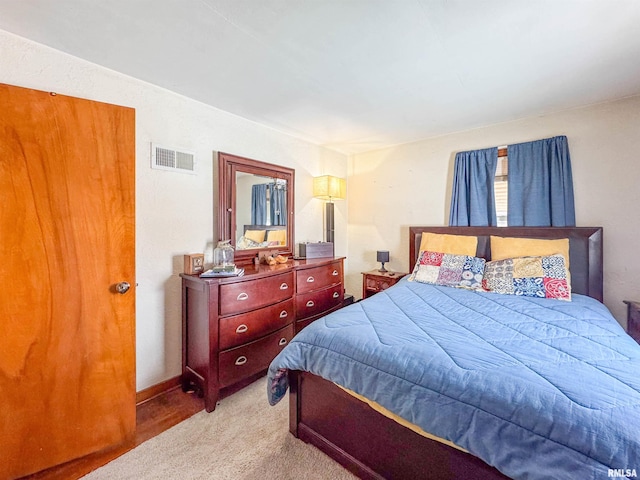 bedroom with light colored carpet