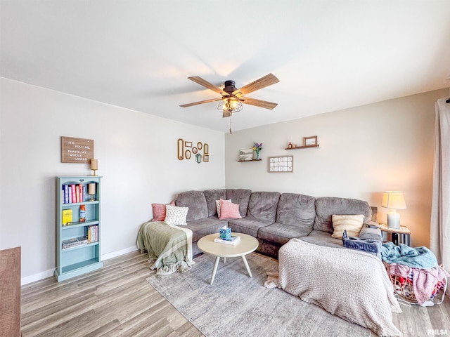 living room featuring ceiling fan and light hardwood / wood-style floors