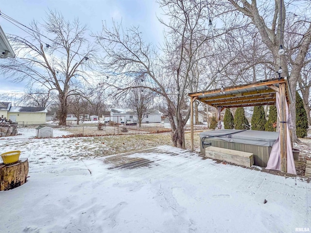 yard layered in snow with a hot tub