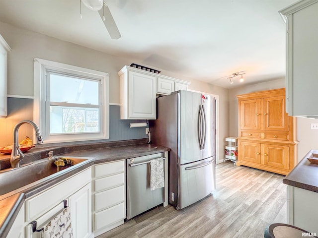 kitchen with sink, ceiling fan, stainless steel appliances, light hardwood / wood-style floors, and white cabinets