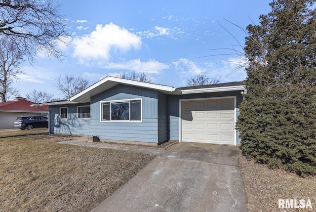 single story home featuring a garage and a front yard