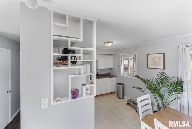 kitchen featuring ornamental molding and white cabinets