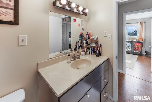 bathroom featuring vanity, toilet, and wood-type flooring