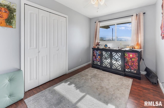 bedroom featuring ceiling fan, dark hardwood / wood-style flooring, and a closet