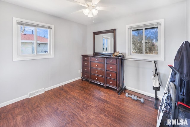 bedroom with dark hardwood / wood-style floors and ceiling fan