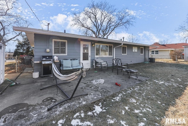 back of house with central AC unit, a fire pit, and a patio