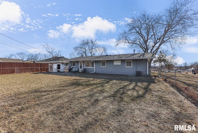 rear view of property featuring a yard, a patio area, and central air condition unit