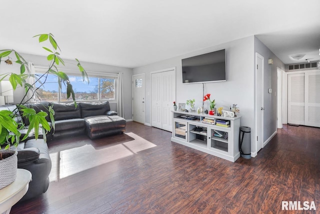 living room with dark hardwood / wood-style flooring