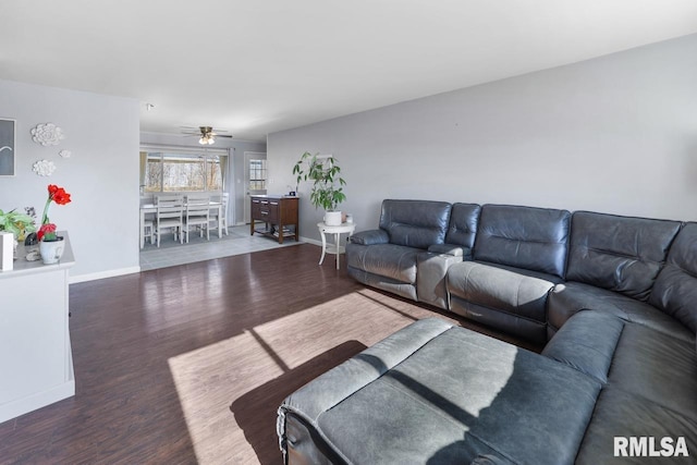 living room featuring ceiling fan and dark hardwood / wood-style flooring