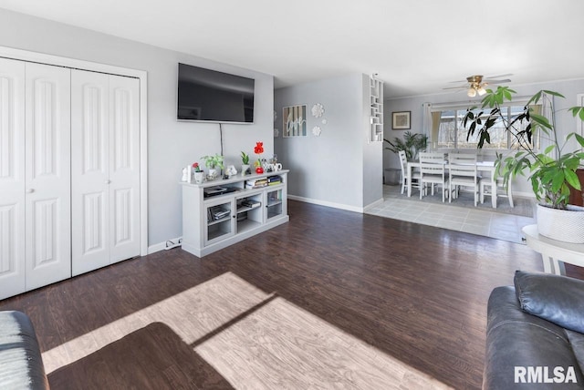 living room with wood-type flooring and ceiling fan