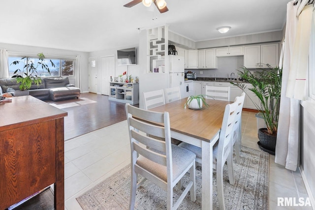 tiled dining area with ceiling fan