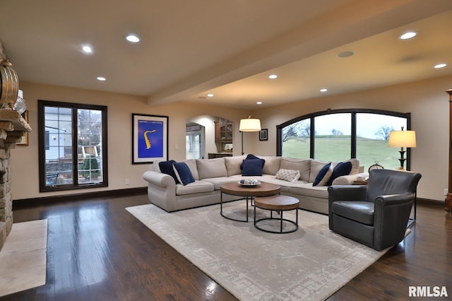 living room with dark wood-type flooring and beam ceiling