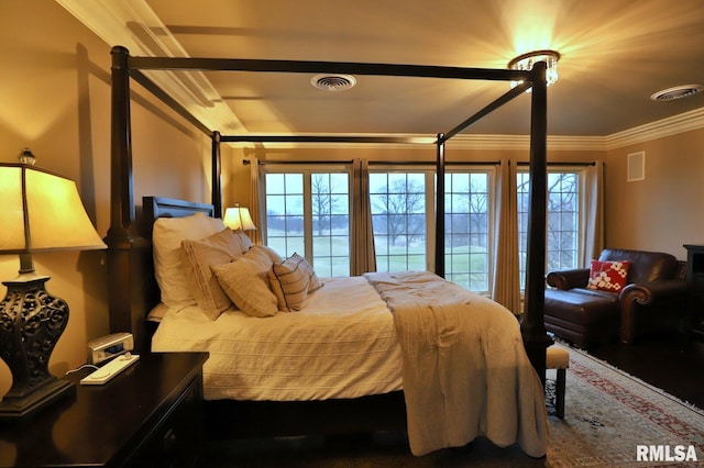 bedroom featuring multiple windows and crown molding