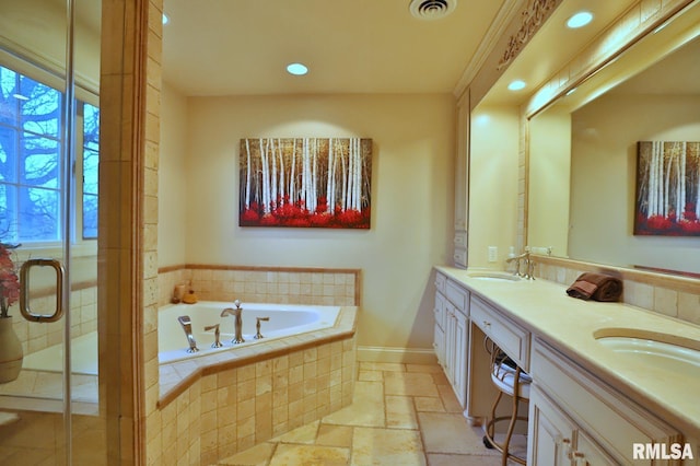 bathroom featuring vanity, a healthy amount of sunlight, and separate shower and tub