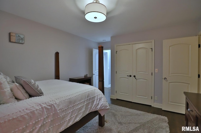 bedroom with dark wood-type flooring and a closet