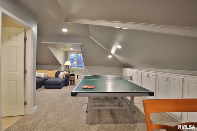 recreation room with vaulted ceiling and light carpet