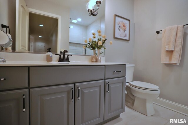 bathroom featuring tile patterned flooring, vanity, and toilet