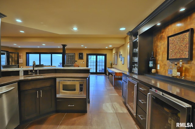 kitchen with wine cooler, sink, and stainless steel appliances