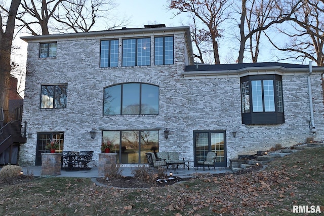 back of property with a patio