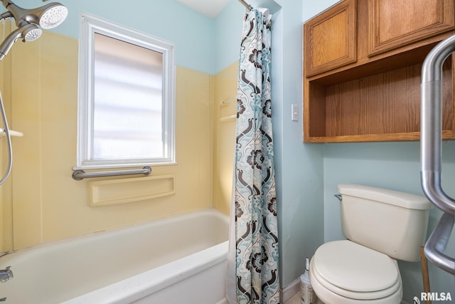 bathroom featuring shower / tub combo and toilet