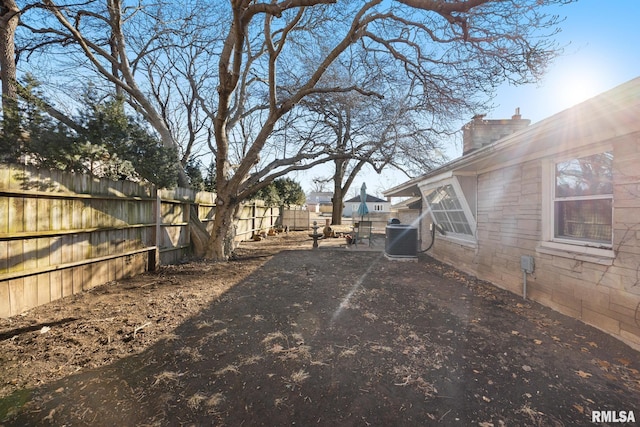 view of yard with central AC and a patio area