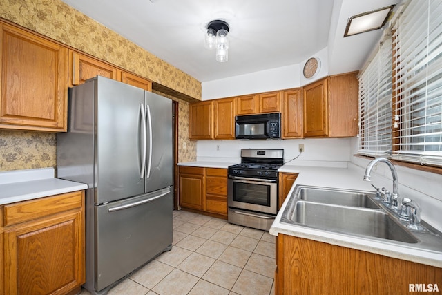 kitchen featuring appliances with stainless steel finishes, sink, and light tile patterned floors