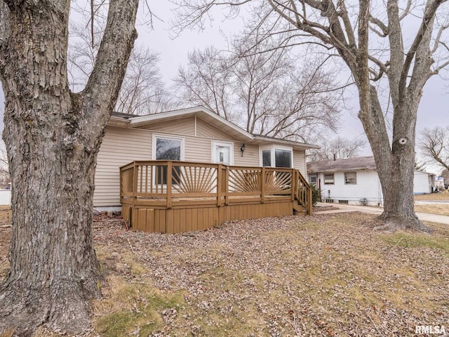 rear view of property featuring a deck