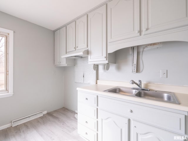 kitchen featuring a baseboard radiator, sink, white cabinets, and light hardwood / wood-style floors