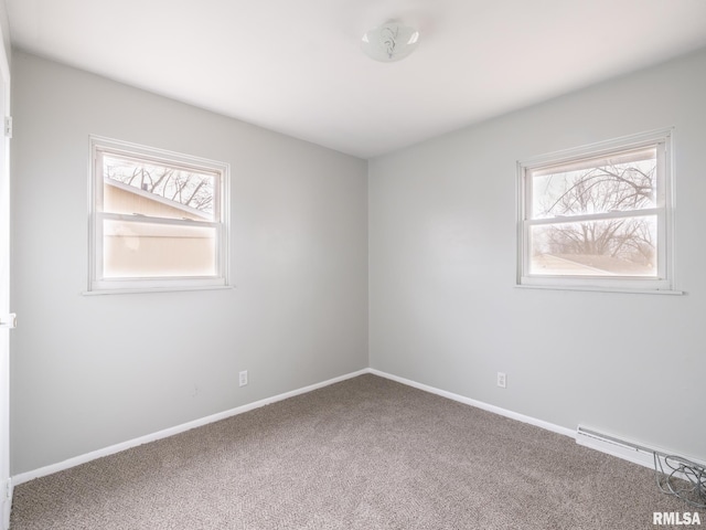 unfurnished room featuring carpet, a healthy amount of sunlight, and baseboard heating