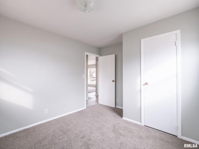 unfurnished bedroom with light colored carpet