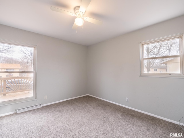 carpeted spare room featuring a wealth of natural light and ceiling fan