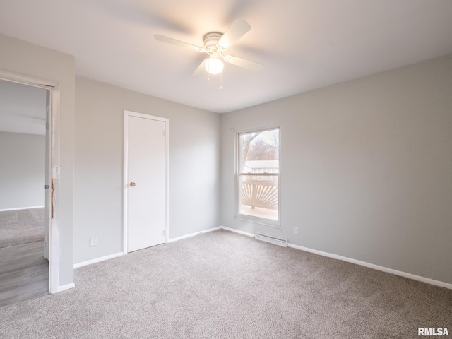 spare room with ceiling fan and carpet