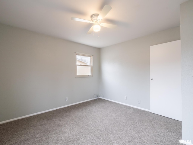 carpeted spare room featuring ceiling fan