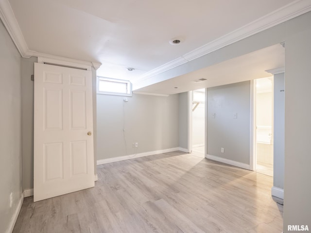 basement with ornamental molding and light wood-type flooring