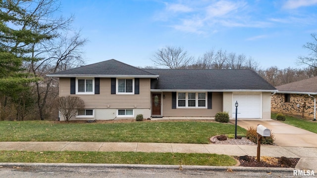 tri-level home featuring a garage and a front yard