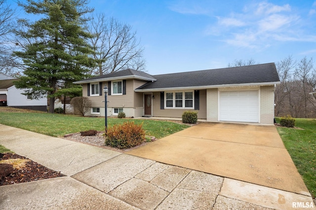 tri-level home featuring a garage and a front yard