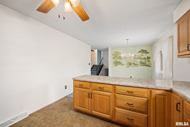 kitchen featuring light carpet, decorative light fixtures, and ceiling fan with notable chandelier