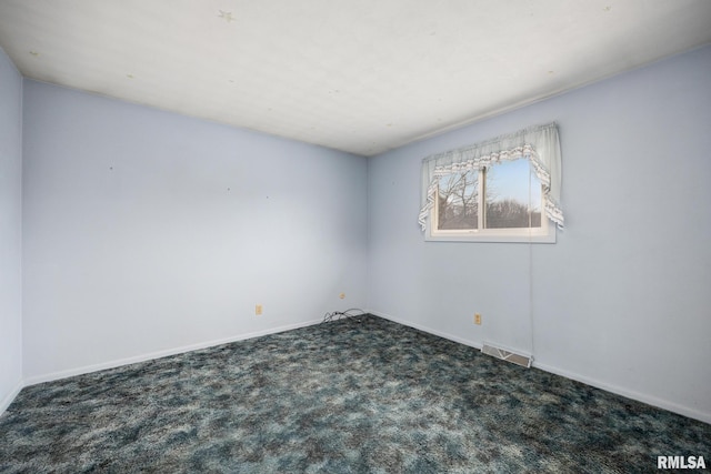 empty room with dark carpet