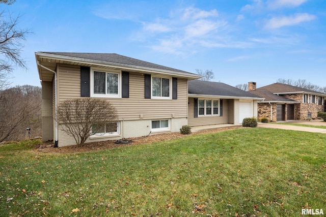 tri-level home with a garage and a front yard