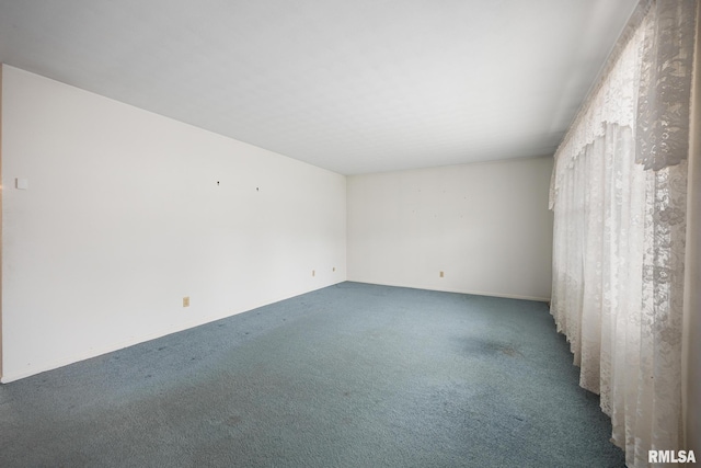 empty room with dark carpet